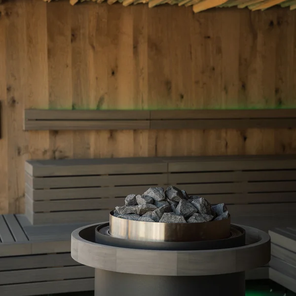 Le foto dell’Elgus Nature Retreat Interno di una sauna con panche in legno e pietre riscaldanti al centro
